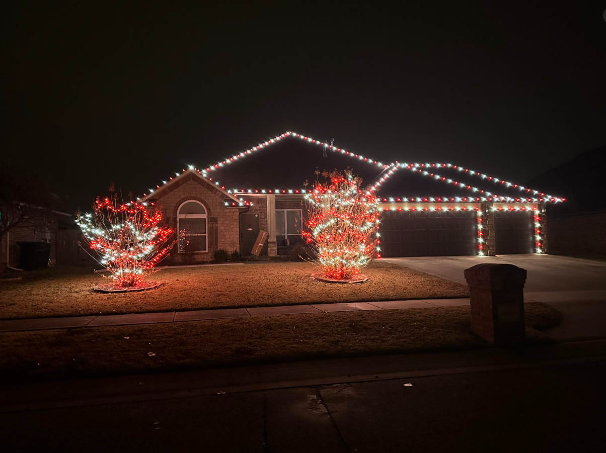Home decorated with red and white Christmas lights